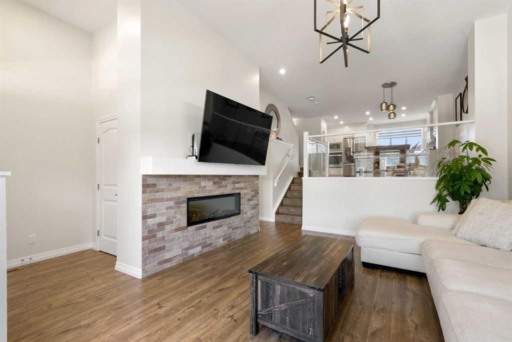 31 Magnolia Grove Se, Calgary, AB - Indoor Photo Showing Living Room With Fireplace
