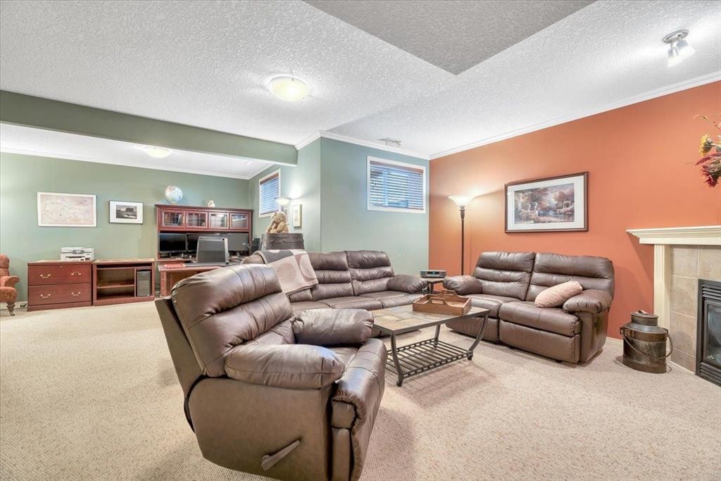 141 Ridgestone Lane, Diamond Valley, AB - Indoor With Fireplace