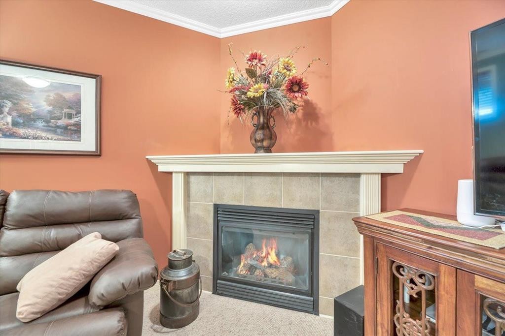 141 Ridgestone Lane, Diamond Valley, AB - Indoor Photo Showing Other Room With Fireplace