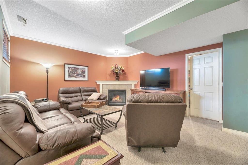 141 Ridgestone Lane, Diamond Valley, AB - Indoor Photo Showing Living Room With Fireplace