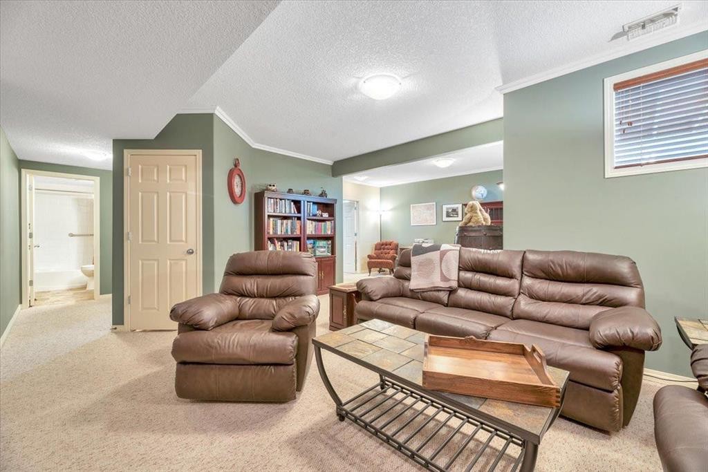 141 Ridgestone Lane, Diamond Valley, AB - Indoor Photo Showing Living Room