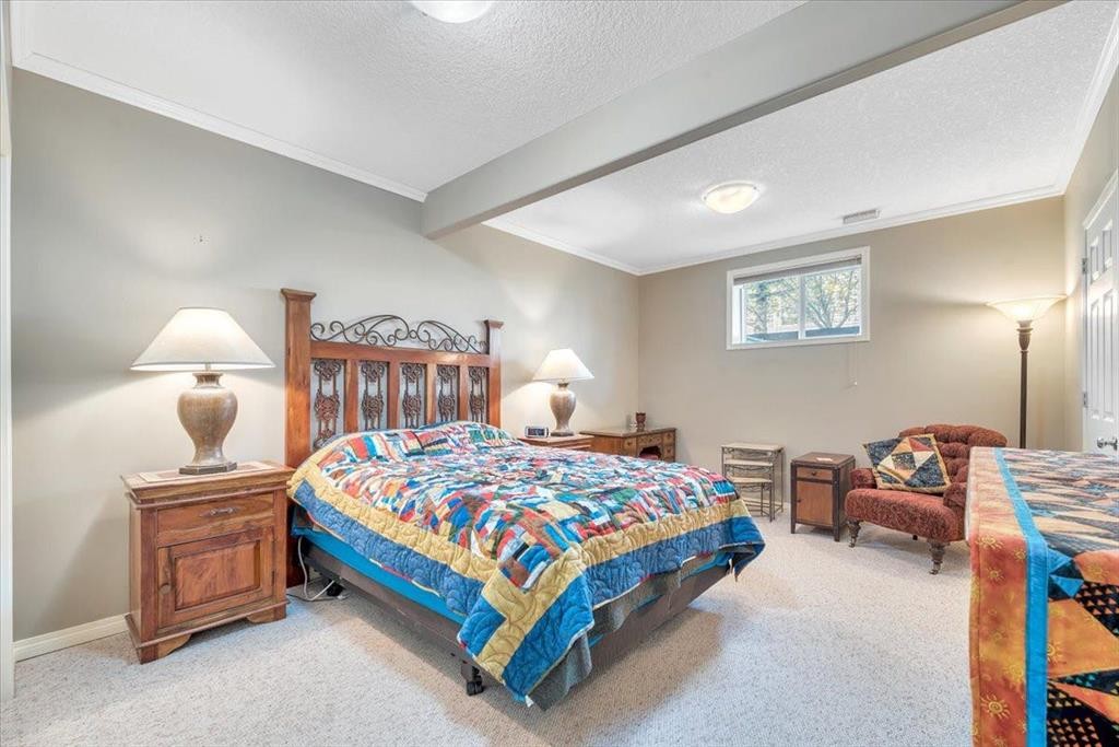 141 Ridgestone Lane, Diamond Valley, AB - Indoor Photo Showing Bedroom