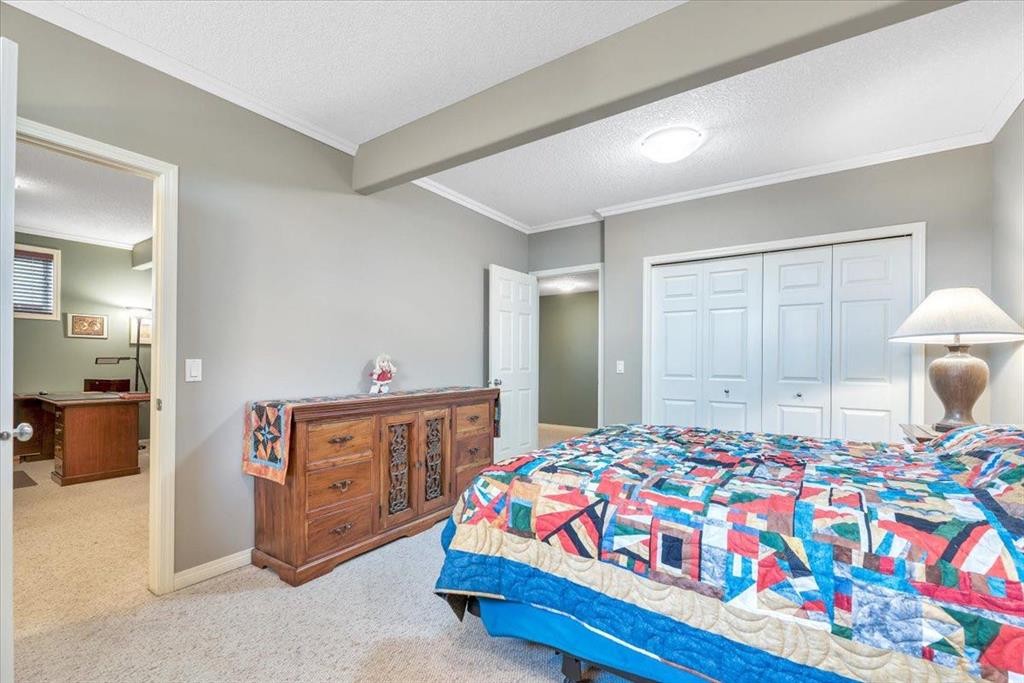 141 Ridgestone Lane, Diamond Valley, AB - Indoor Photo Showing Bedroom