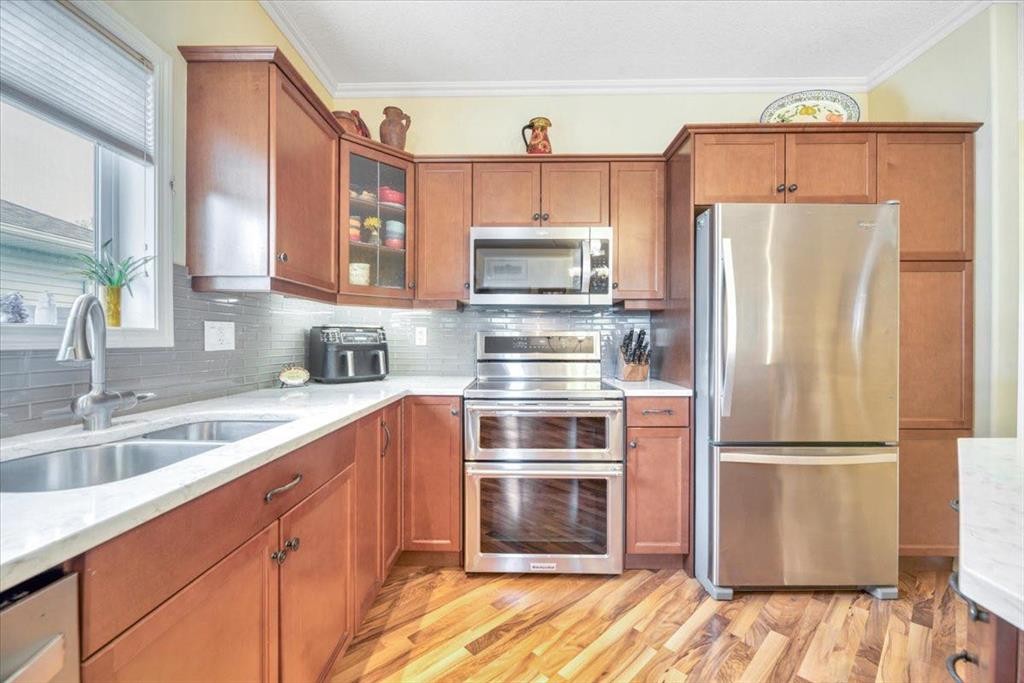 141 Ridgestone Lane, Diamond Valley, AB - Indoor Photo Showing Kitchen With Double Sink With Upgraded Kitchen