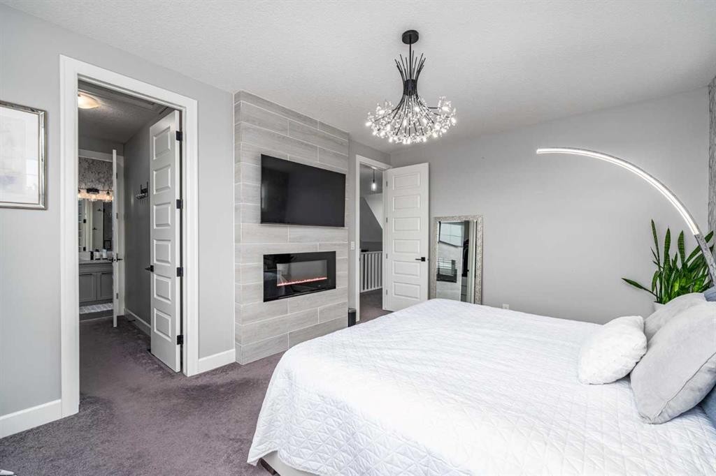 46 Yorkstone Way Sw, Calgary, AB - Indoor Photo Showing Bedroom With Fireplace