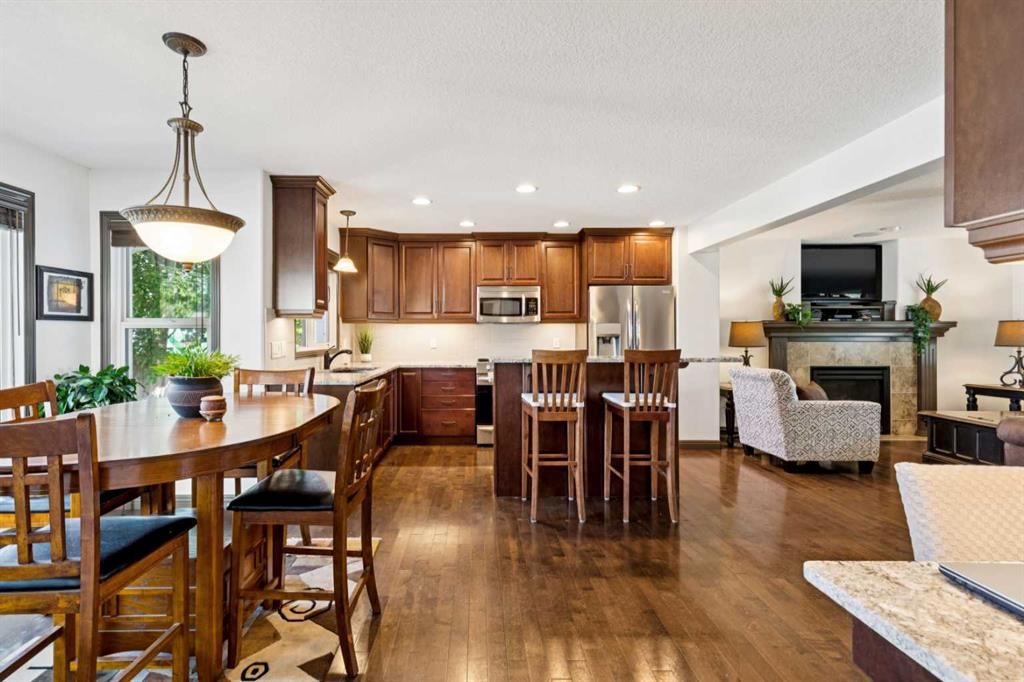 316 Prestwick Terrace Se, Calgary, AB - Indoor Photo Showing Dining Room With Fireplace