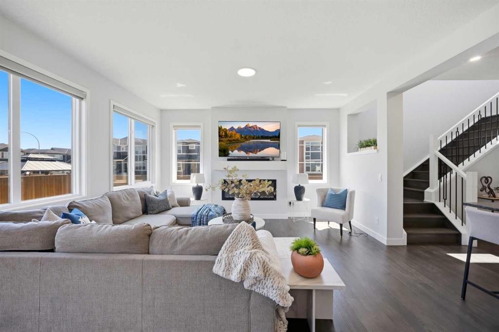 114 Corner Meadows Grove Ne, Calgary, AB - Indoor Photo Showing Living Room With Fireplace