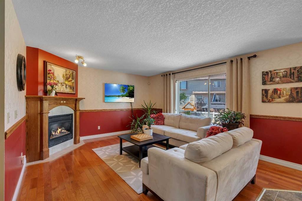 84 Willowbrook Crescent Nw, Airdrie, AB - Indoor Photo Showing Living Room With Fireplace