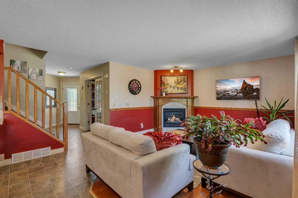 84 Willowbrook Crescent Nw, Airdrie, AB - Indoor Photo Showing Living Room With Fireplace