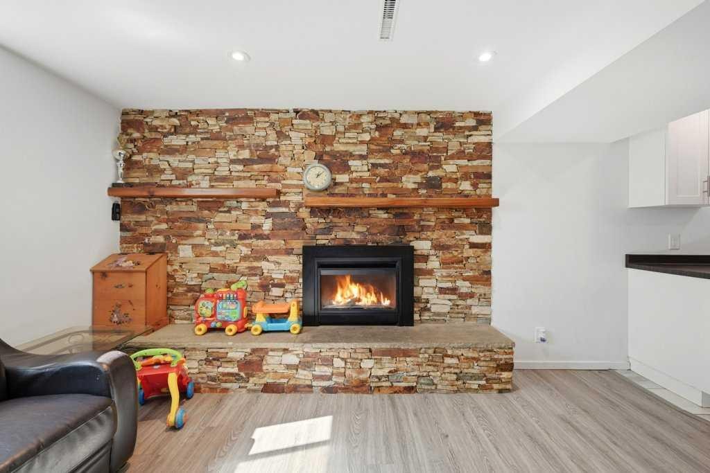 2415 Vista Crescent Ne, Calgary, AB - Indoor Photo Showing Living Room With Fireplace