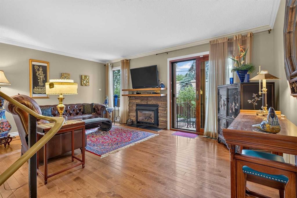 12-140 Point Drive Nw, Calgary, AB - Indoor Photo Showing Living Room With Fireplace