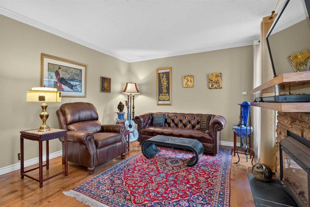 12-140 Point Drive Nw, Calgary, AB - Indoor Photo Showing Living Room With Fireplace