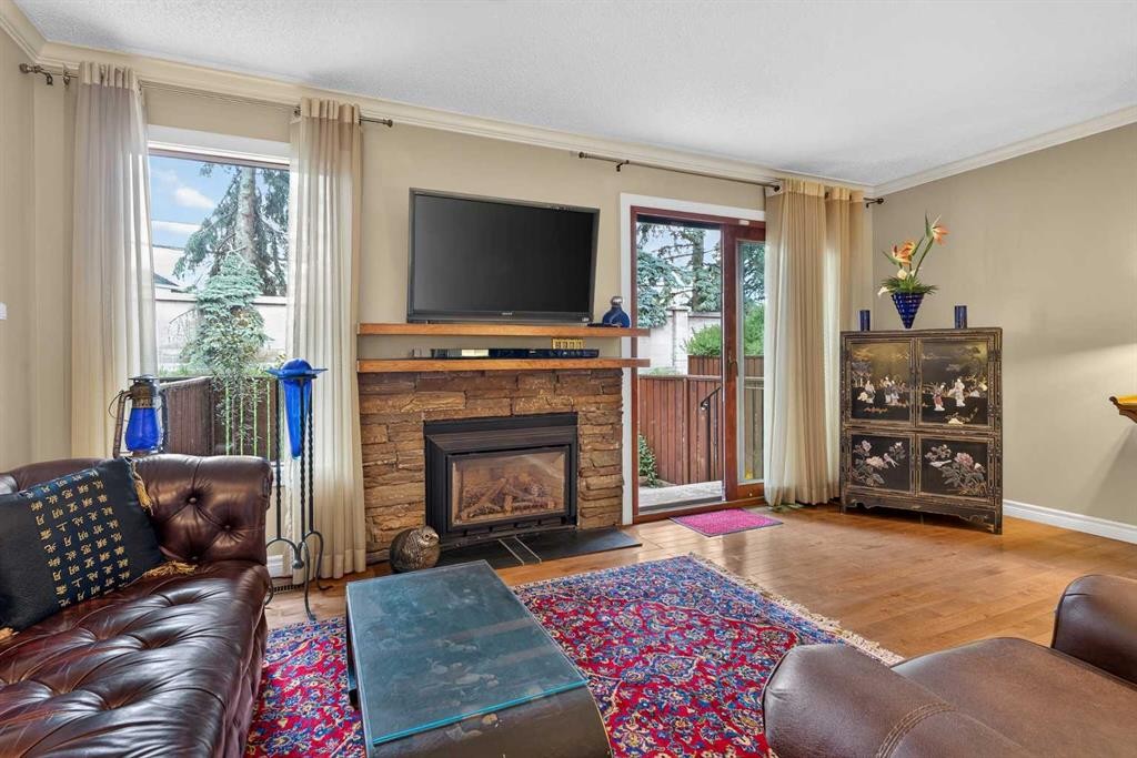 12-140 Point Drive Nw, Calgary, AB - Indoor Photo Showing Living Room With Fireplace