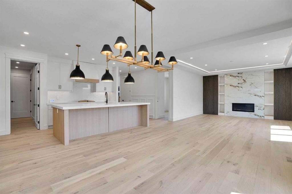 287 Waterford Road, Chestermere, AB - Indoor Photo Showing Kitchen With Fireplace