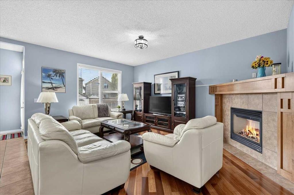 18 Copperstone Drive Se, Calgary, AB - Indoor Photo Showing Living Room With Fireplace
