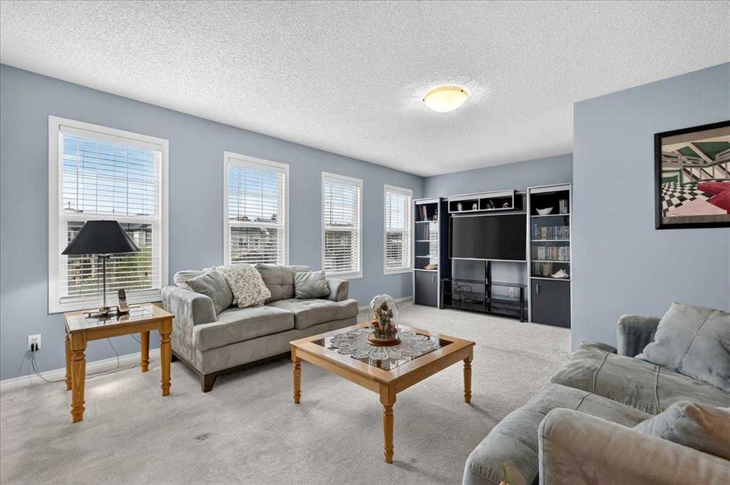 18 Copperstone Drive Se, Calgary, AB - Indoor Photo Showing Living Room