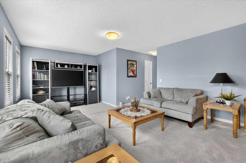 18 Copperstone Drive Se, Calgary, AB - Indoor Photo Showing Living Room