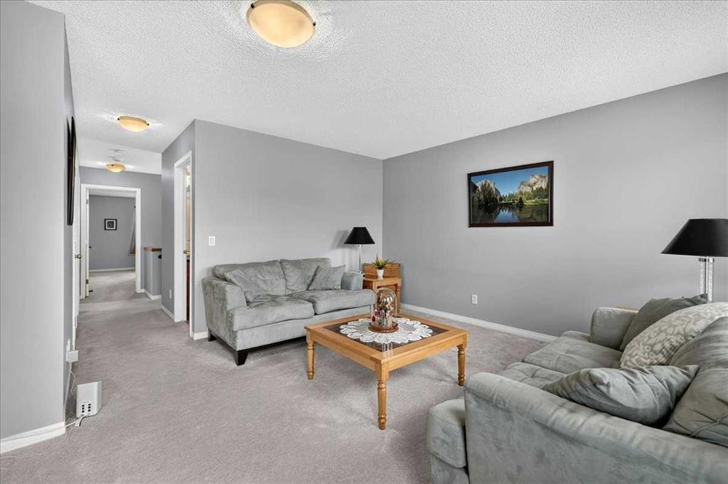 18 Copperstone Drive Se, Calgary, AB - Indoor Photo Showing Living Room