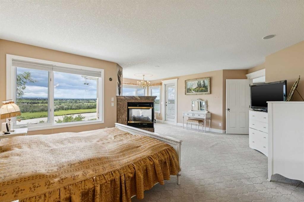 85 Mt Douglas Circle Se, Calgary, AB - Indoor Photo Showing Bedroom With Fireplace