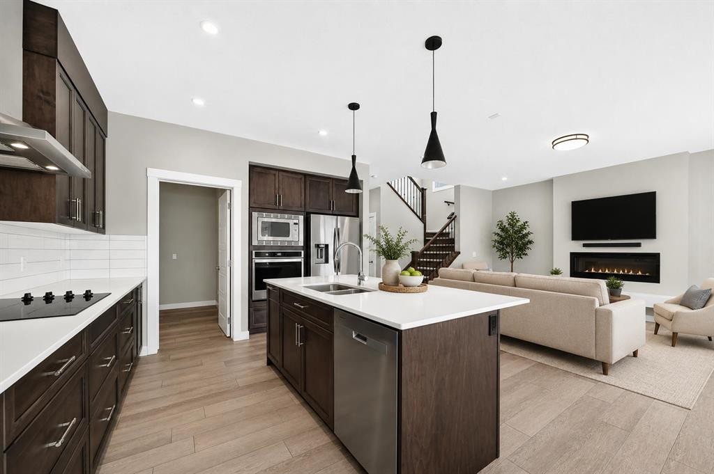 137 Creekside Way Sw, Calgary, AB - Indoor Photo Showing Kitchen With Fireplace With Double Sink With Upgraded Kitchen