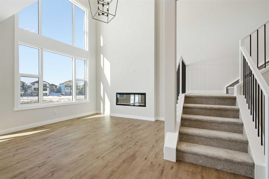 358 Kinniburgh Loop, Chestermere, AB - Indoor Photo Showing Other Room With Fireplace
