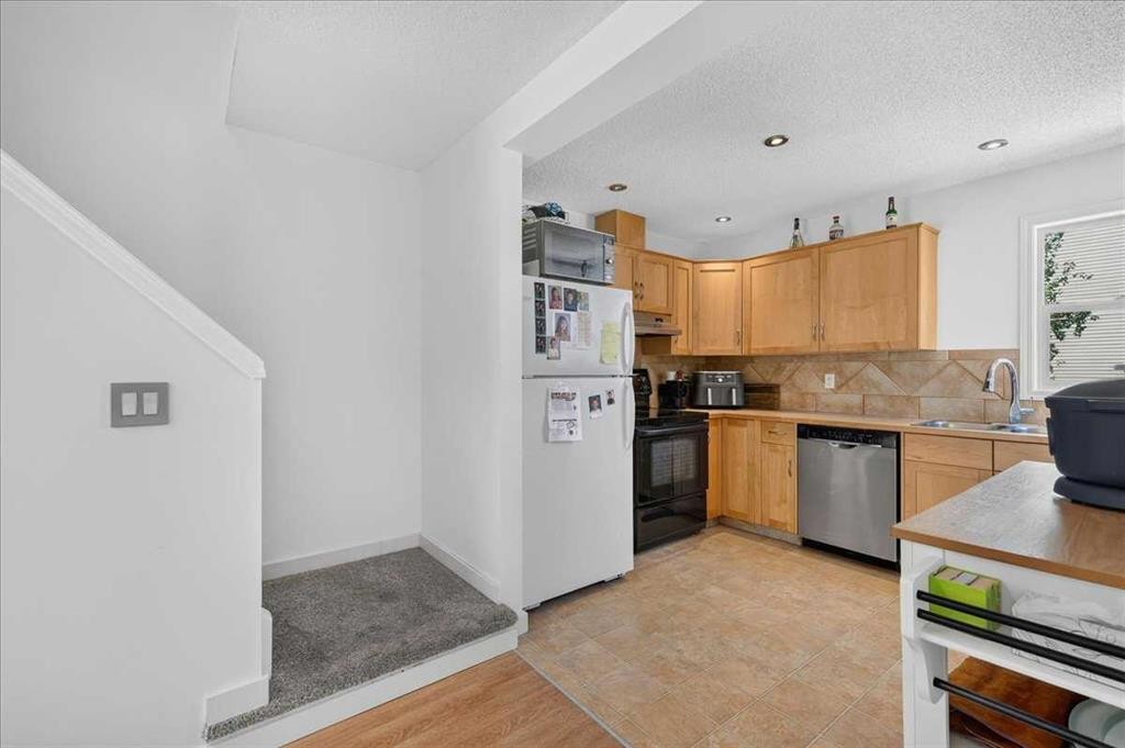 137 Bridlewood Lane Sw, Calgary, AB - Indoor Photo Showing Kitchen With Double Sink