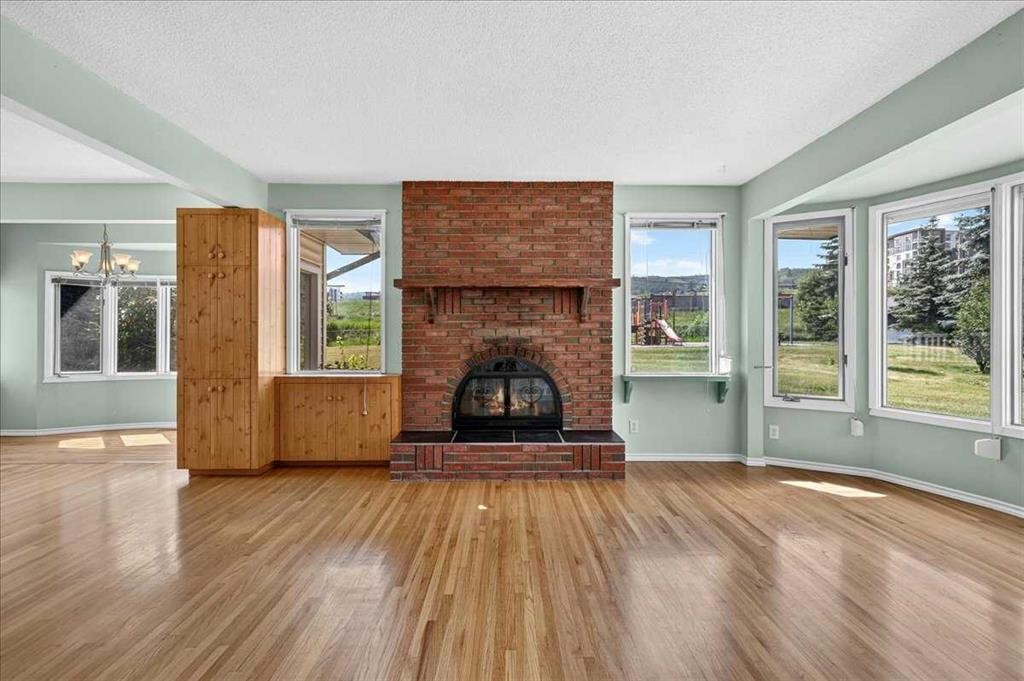 7727 Bowcliffe Crescent Nw, Calgary, AB - Indoor Photo Showing Living Room With Fireplace