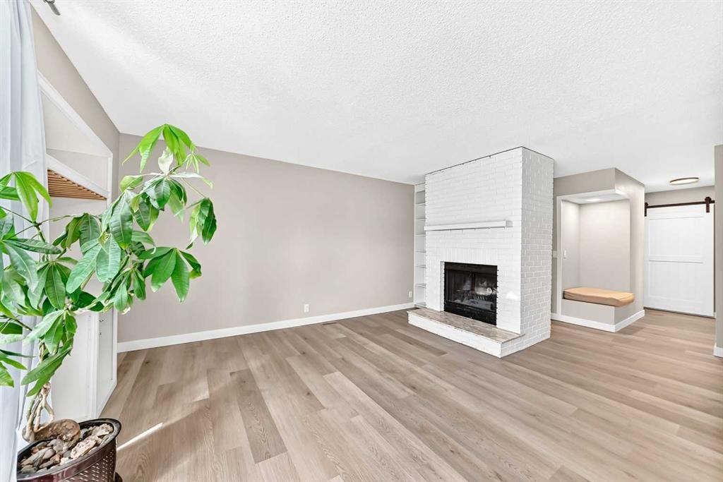 114 Midcrest Crescent Se, Calgary, AB - Indoor Photo Showing Living Room With Fireplace