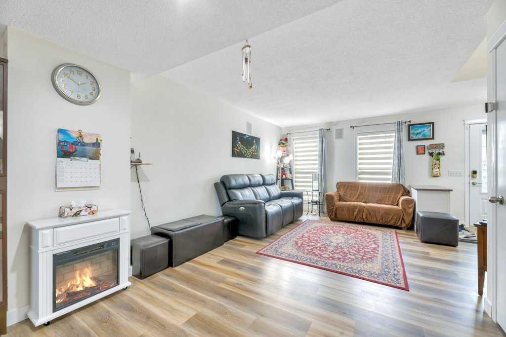 175 Prestwick Villas Se, Calgary, AB - Indoor Photo Showing Living Room With Fireplace