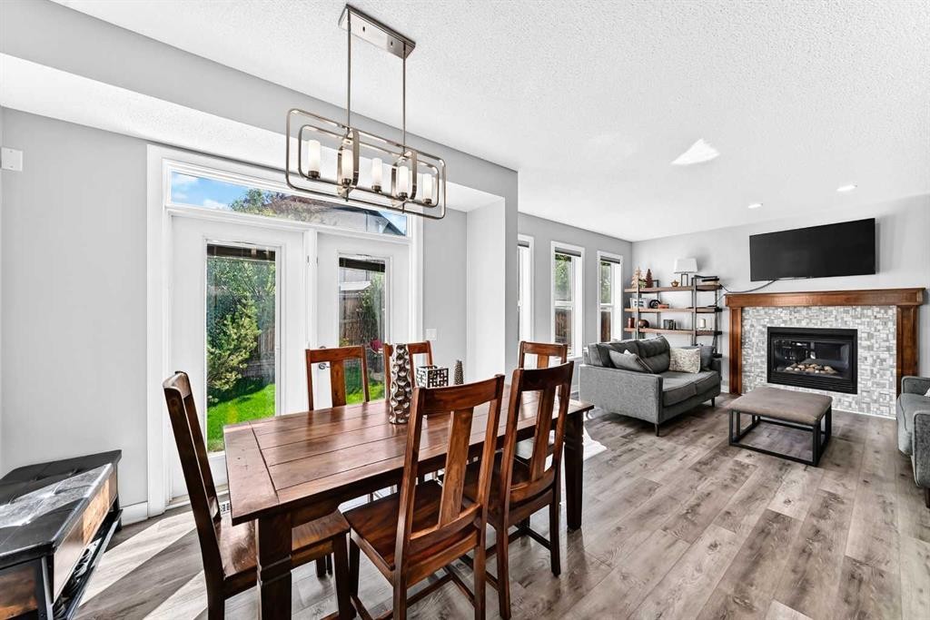 144 Pantego Close Nw, Calgary, AB - Indoor Photo Showing Dining Room With Fireplace