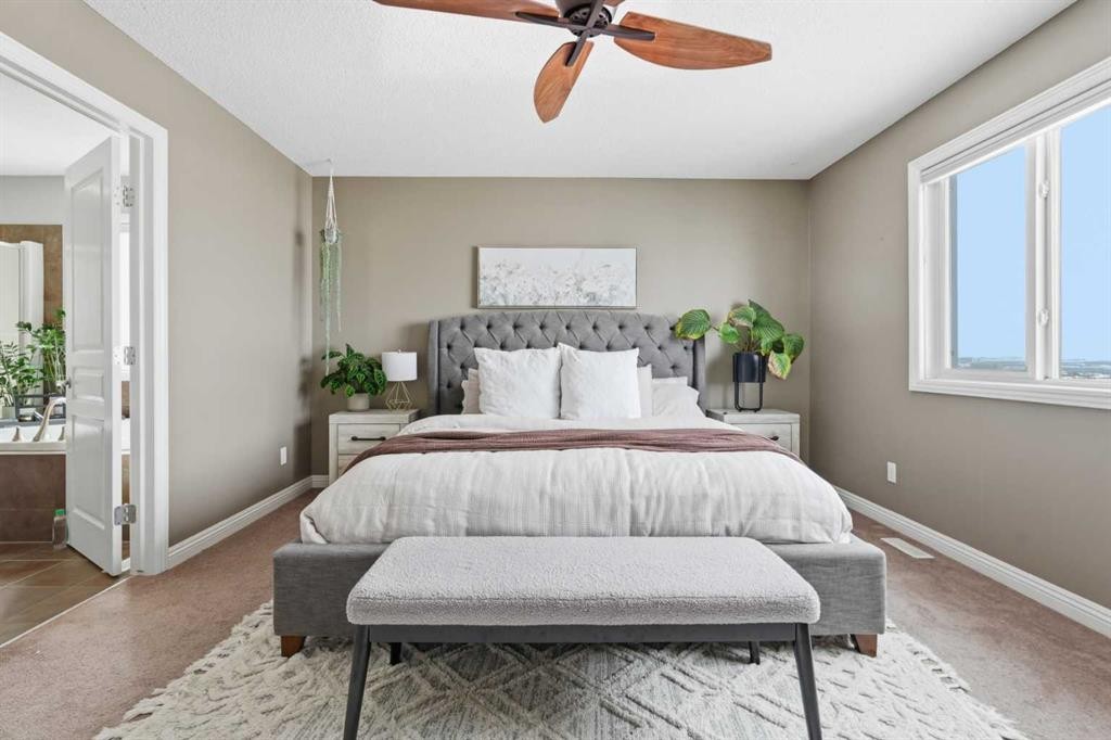 99 Sunset View, Cochrane, AB - Indoor Photo Showing Bedroom