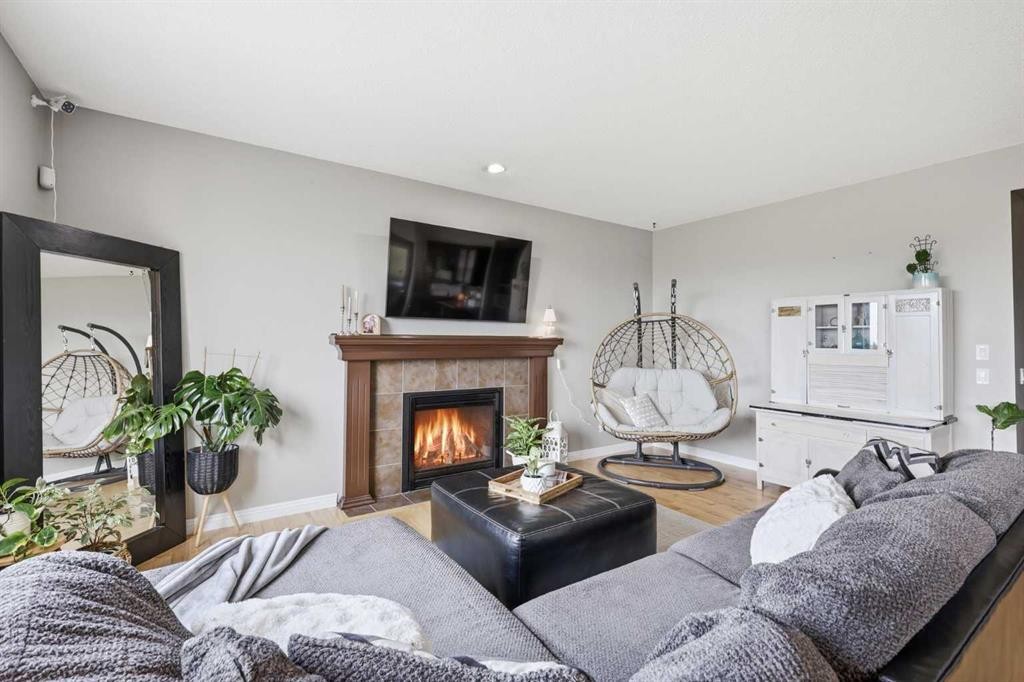 99 Sunset View, Cochrane, AB - Indoor Photo Showing Living Room With Fireplace