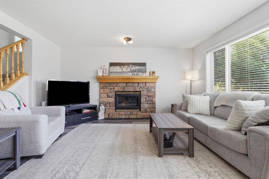134 Prestwick Landing Se, Calgary, AB - Indoor Photo Showing Living Room With Fireplace