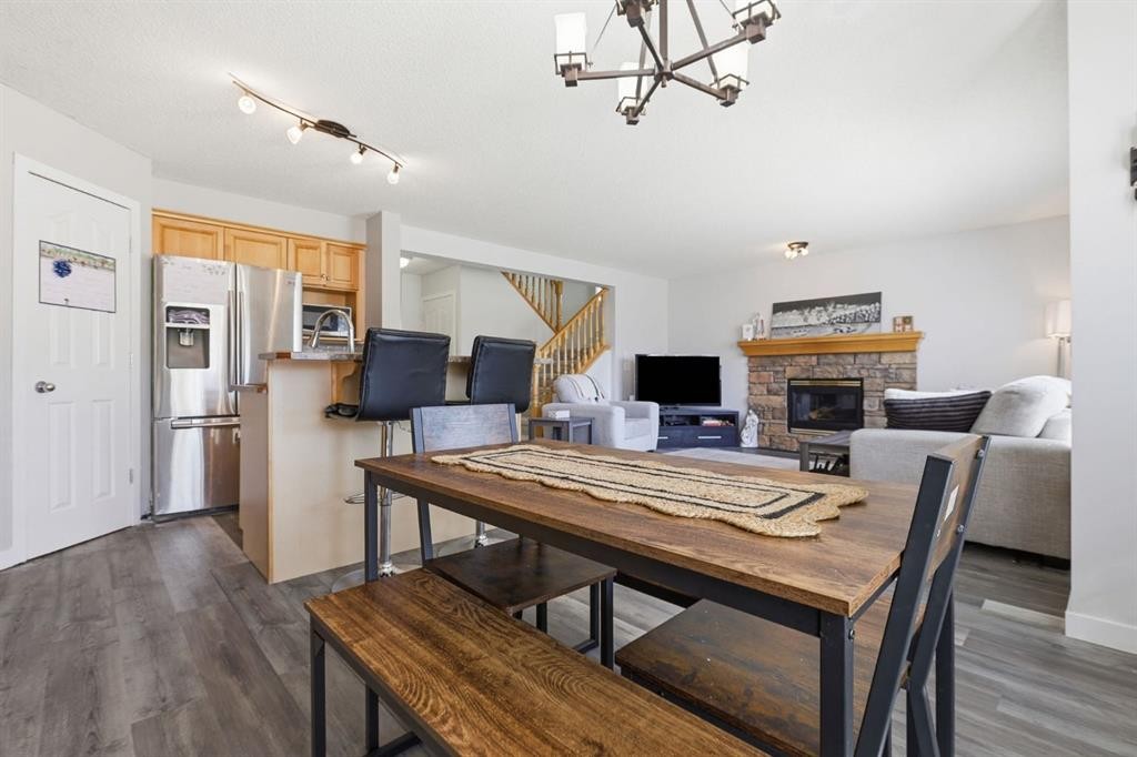 134 Prestwick Landing Se, Calgary, AB - Indoor Photo Showing Dining Room With Fireplace