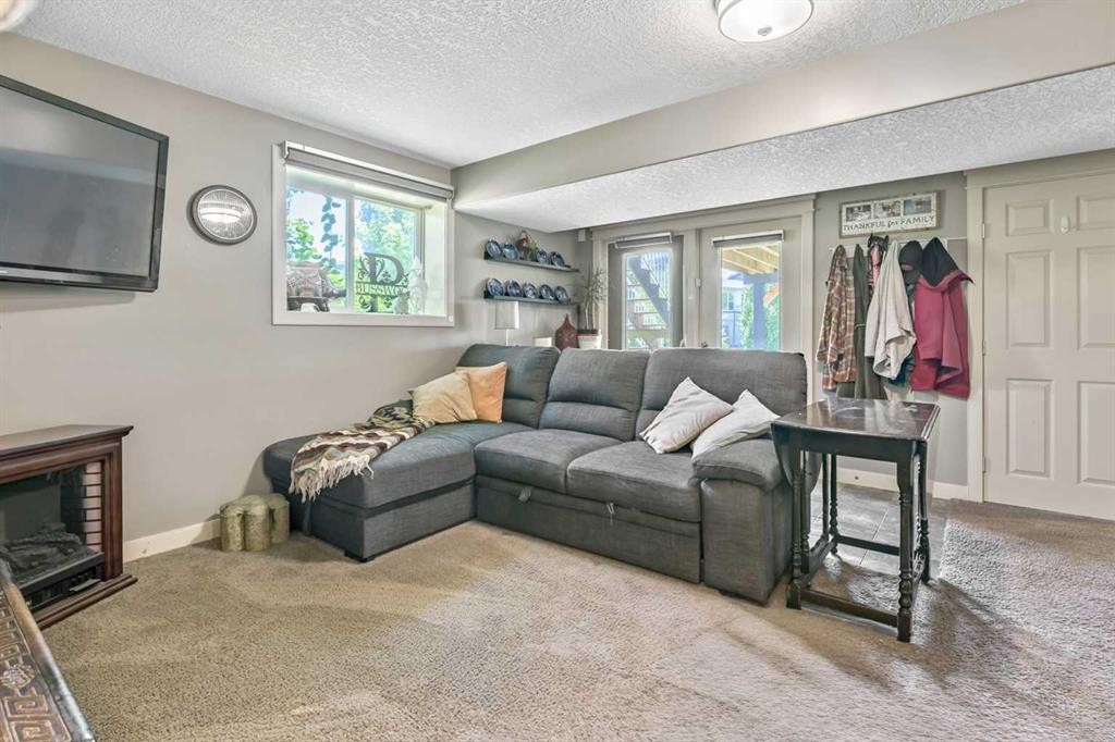 13 Dain Place Nw, Langdon, AB - Indoor Photo Showing Living Room With Fireplace