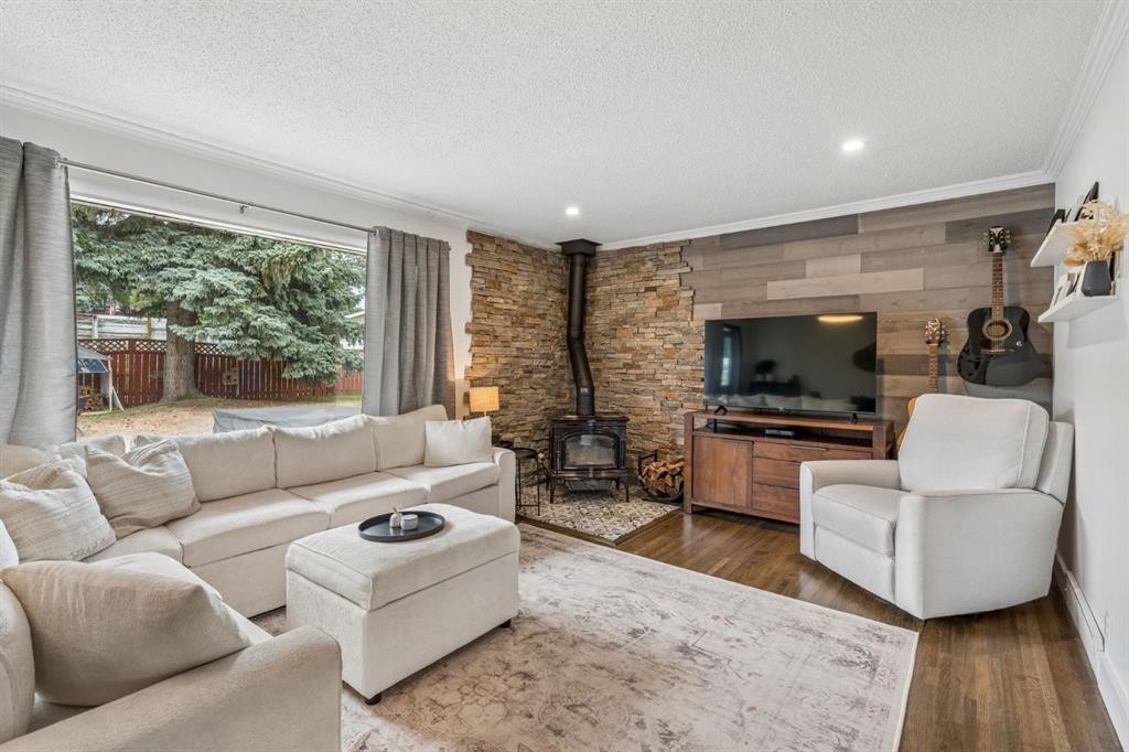 27 Heston Street Nw, Calgary, AB - Indoor Photo Showing Living Room With Fireplace