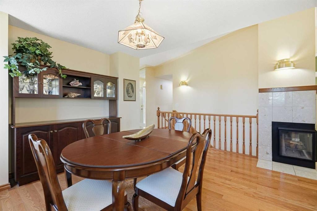 135 Shawnee Rise Sw, Calgary, AB - Indoor Photo Showing Dining Room With Fireplace