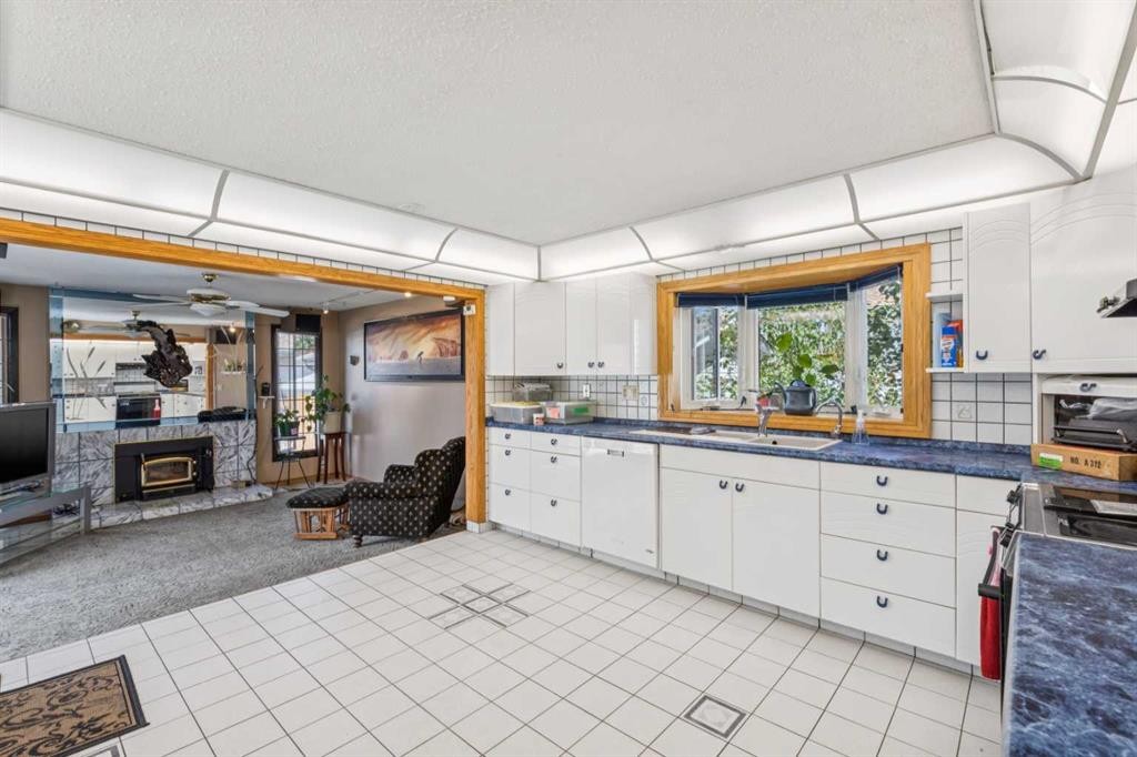 4819 Rundlewood Drive Ne, Calgary, AB - Indoor Photo Showing Kitchen With Fireplace