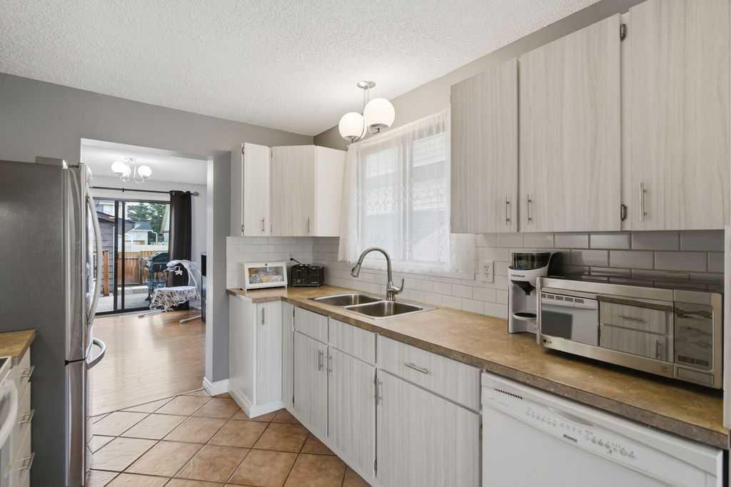 96 Abberfield Crescent Ne, Calgary, AB - Indoor Photo Showing Kitchen With Double Sink
