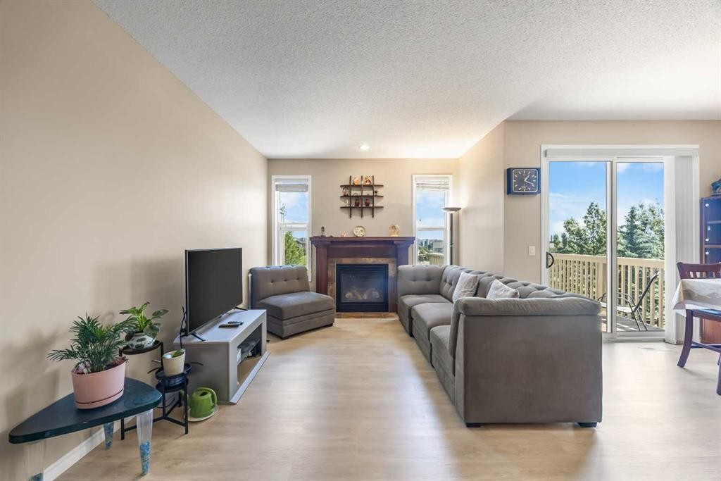 32 Panatella Common Nw, Calgary, AB - Indoor Photo Showing Living Room With Fireplace