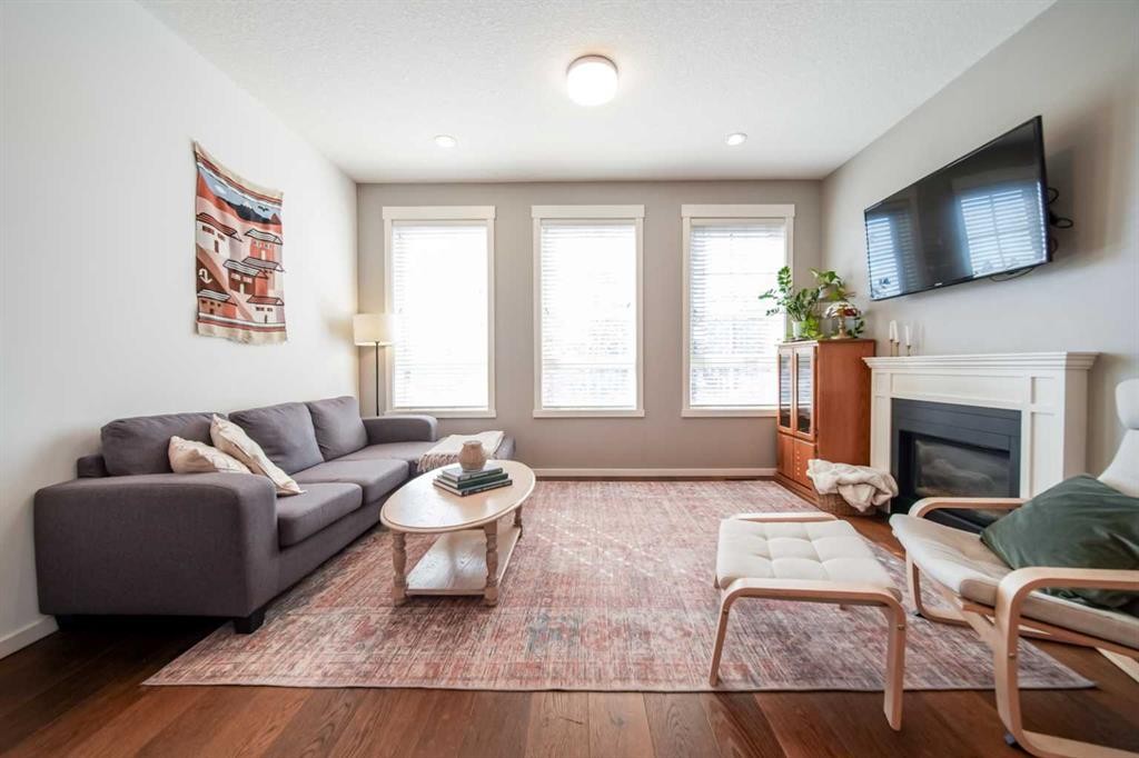 211 Copperpond Common Se, Calgary, AB - Indoor Photo Showing Living Room With Fireplace