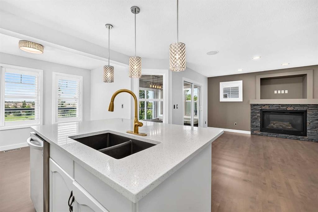 98 Panamount Villas Nw, Calgary, AB - Indoor Photo Showing Kitchen With Fireplace With Double Sink