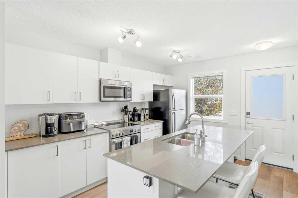 412 Cranbrook Square Se, Calgary, AB - Indoor Photo Showing Kitchen With Stainless Steel Kitchen With Double Sink With Upgraded Kitchen