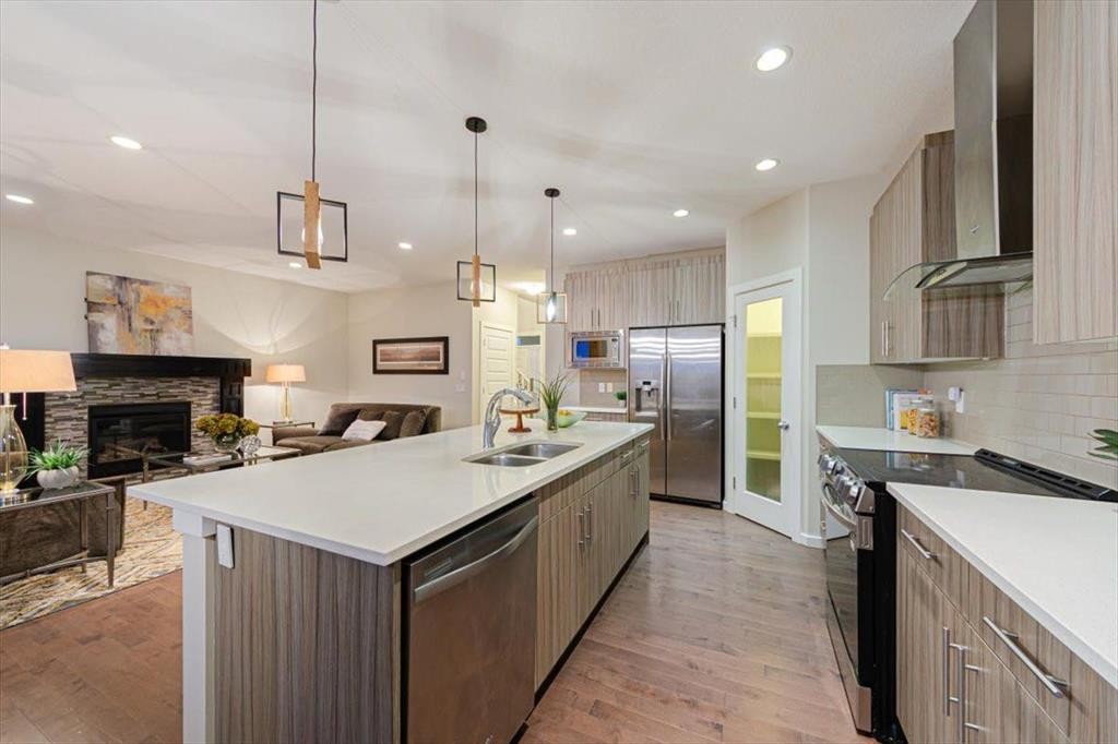 138 Copperpond Street Se, Calgary, AB - Indoor Photo Showing Kitchen With Fireplace With Double Sink With Upgraded Kitchen
