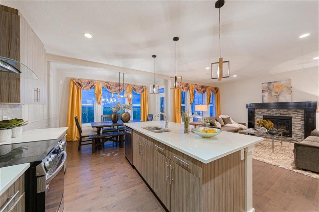 138 Copperpond Street Se, Calgary, AB - Indoor Photo Showing Kitchen With Fireplace With Double Sink