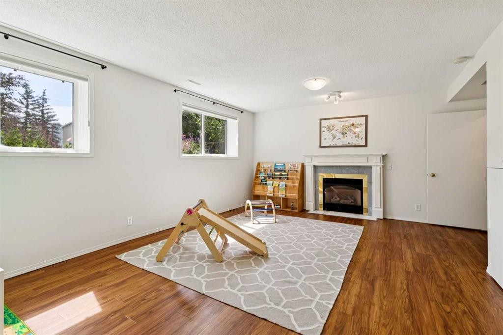 98 River Rock Way Se, Calgary, AB - Indoor Photo Showing Living Room With Fireplace