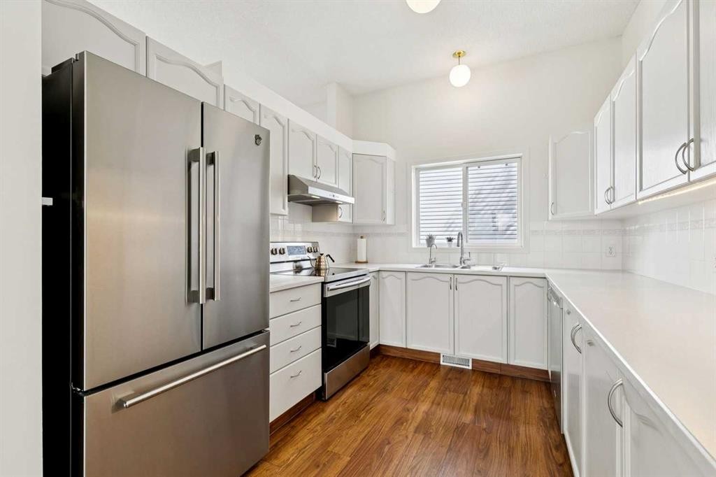 98 River Rock Way Se, Calgary, AB - Indoor Photo Showing Kitchen With Double Sink
