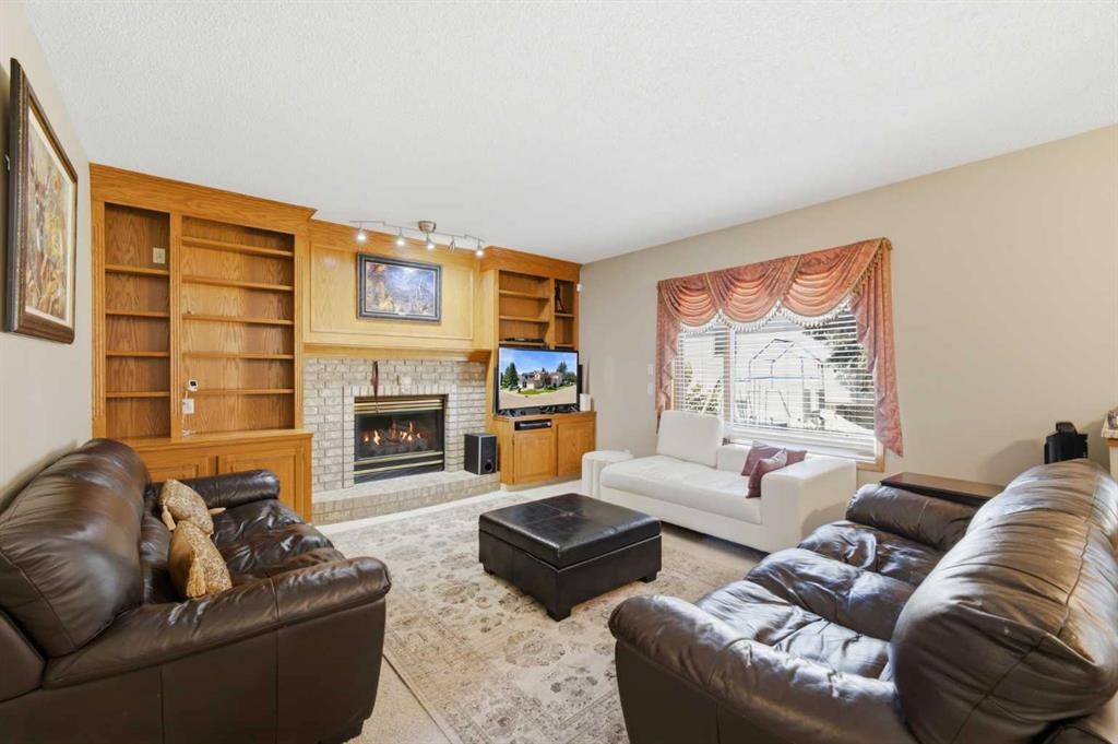 71 Woodpark Close Sw, Calgary, AB - Indoor Photo Showing Living Room With Fireplace