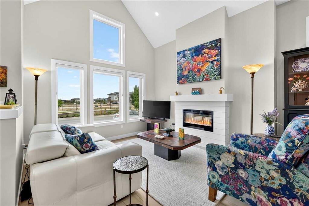 1066 Creekside Boulevard Sw, Calgary, AB - Indoor Photo Showing Living Room With Fireplace