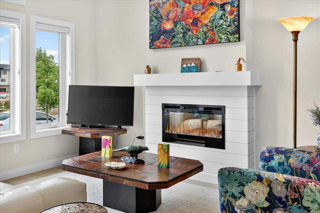 1066 Creekside Boulevard Sw, Calgary, AB - Indoor Photo Showing Living Room With Fireplace